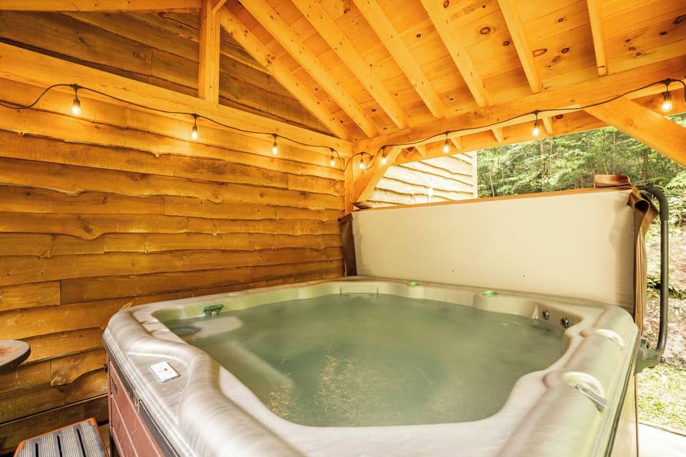 Covered hot tub with privacy fence.