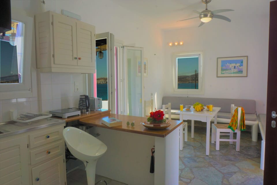 Fully equipped kitchen and sea view living room with stone sofa beds 