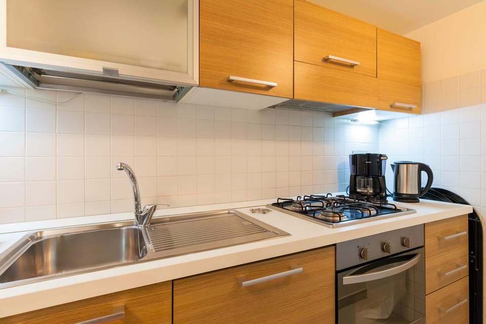 Kitchen equipped for preparing meals, with dishwasher, boiler, coffee maker..