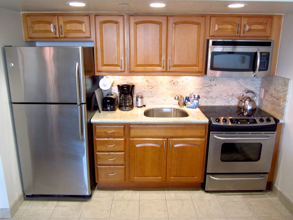 Kitchen fully equipped with utensils and pots and pans.