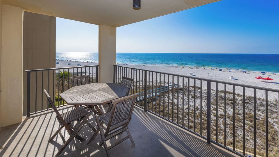 Golden beach views stretch from your balcony as waves lap the shore into the evening for you