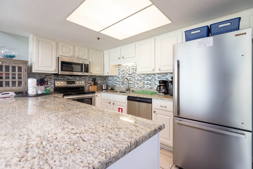 This kitchen features stainless appliances, granite countertops, a Keurig and coffee maker for your convenience
