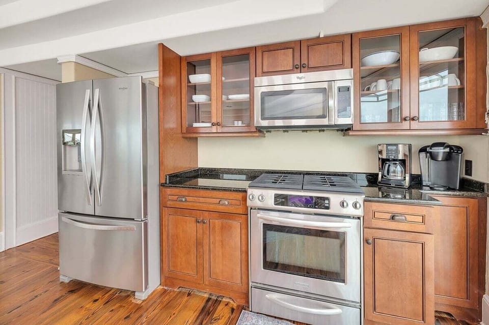 Kitchen with wood cabinets, gas range, and stainless refrigerator