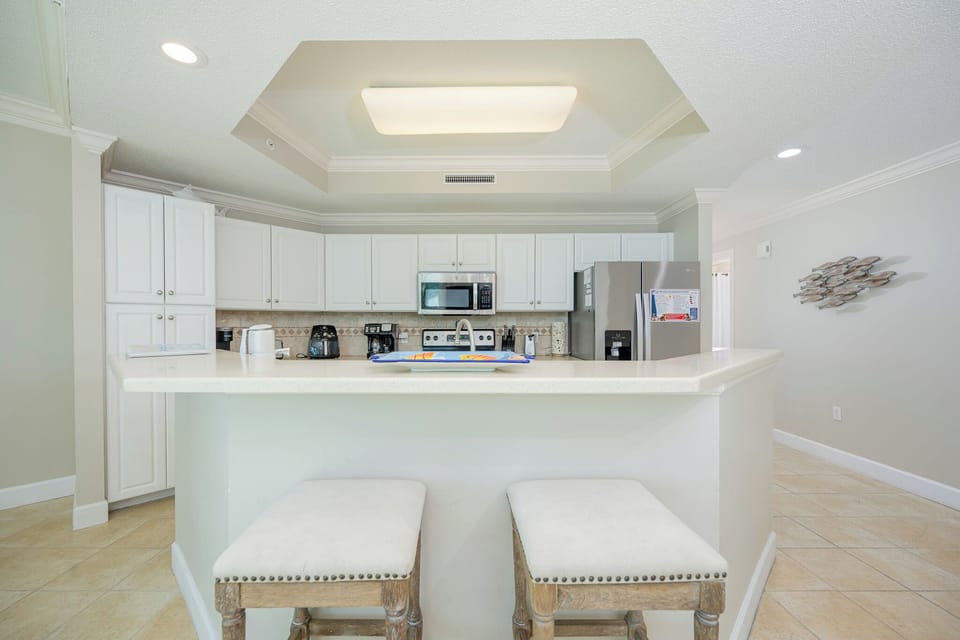 Gather around the breakfast bar, enjoying morning coffee while admiring the inviting kitchen design