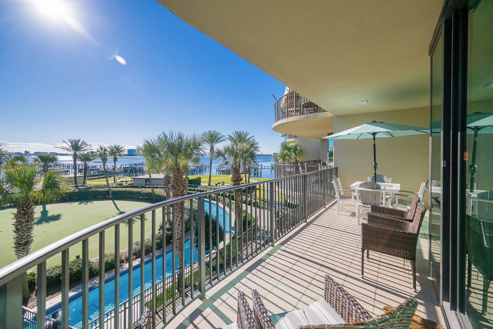 Savor the warmth of the sun while lounging on the balcony, surrounded by lush palms and peaceful bay views