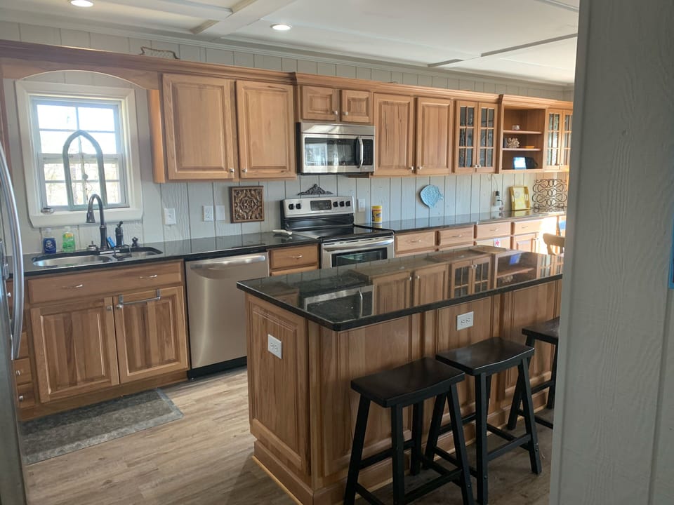 Fully stocked kitchen with seating at island for three