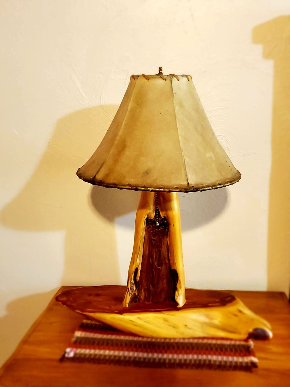 Cedar lamp made by Amish with a beautiful lamp shade on top of a Guatemalean mat