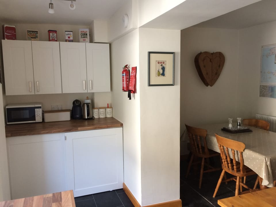 The utility area and dining table - incl washing machine and fridge/ freezer  
