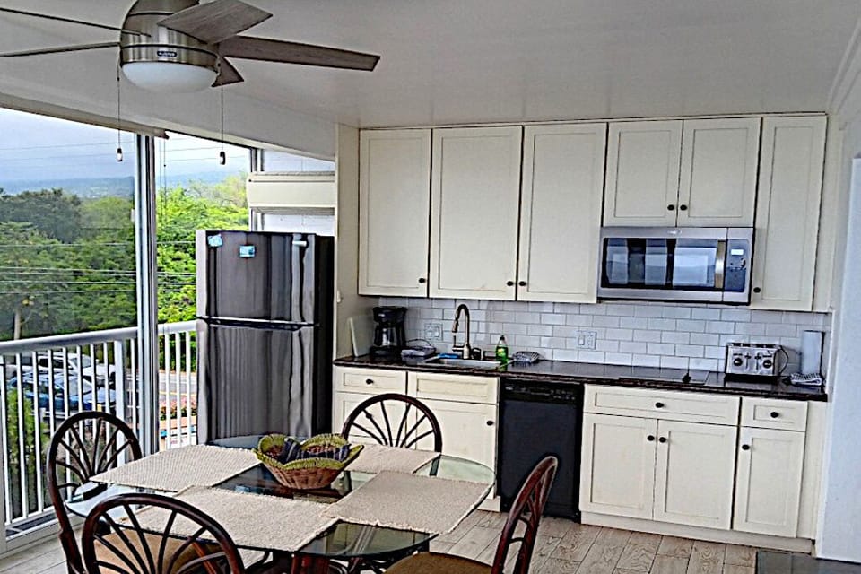 Kitchen with sweeping views of ocean and next-door green park.