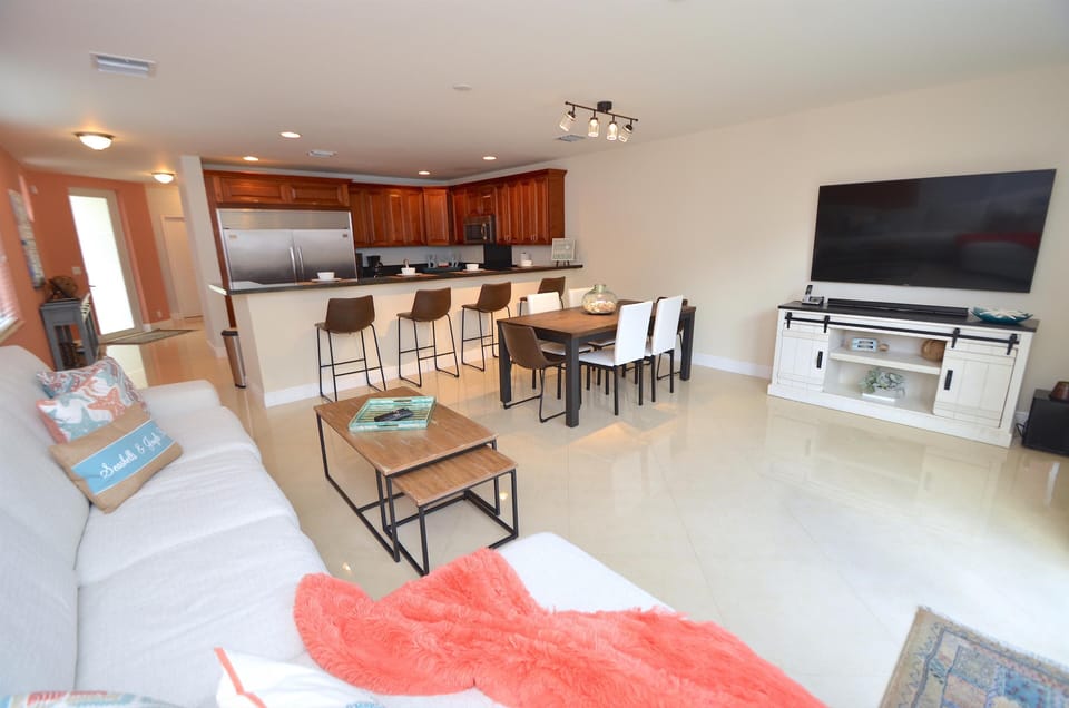 Spacious Open Living Area Features Leather Sectional Sofa + Dining + LED HD TV + Direct Pool Lounge Access...