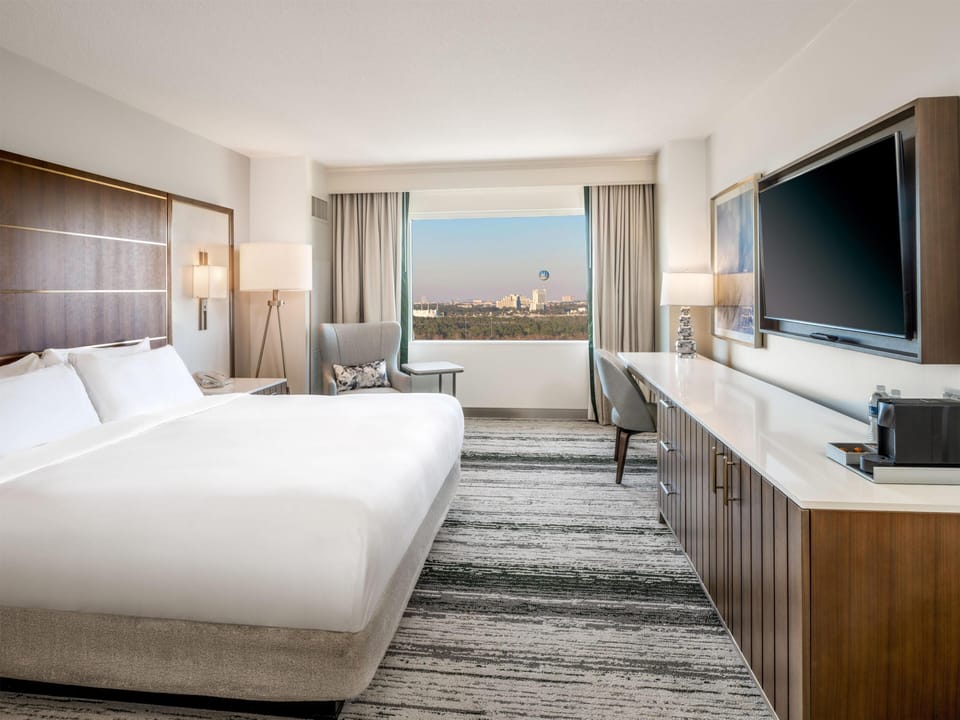 Disney Springs View 1 King Bed Guestroom | Premium bedding, in-room safe, desk, blackout drapes