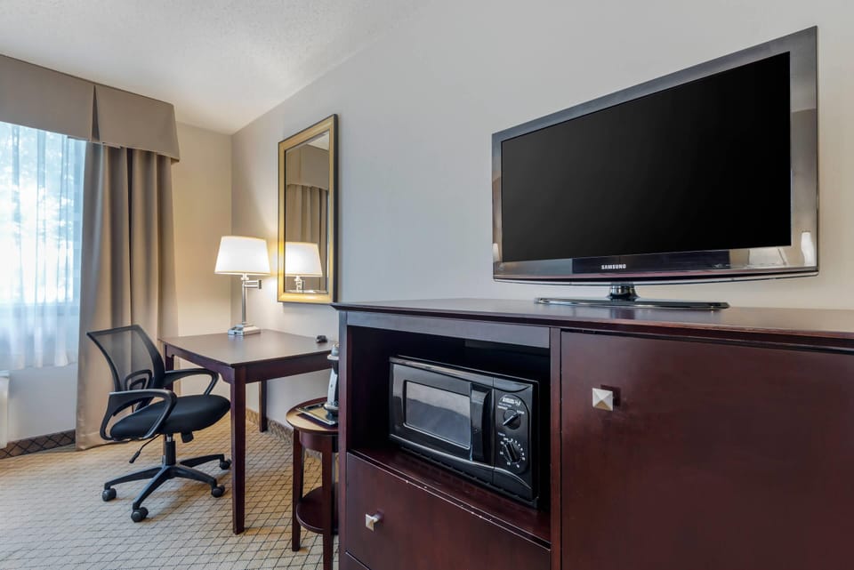 Desk, laptop workspace, blackout drapes, iron/ironing board