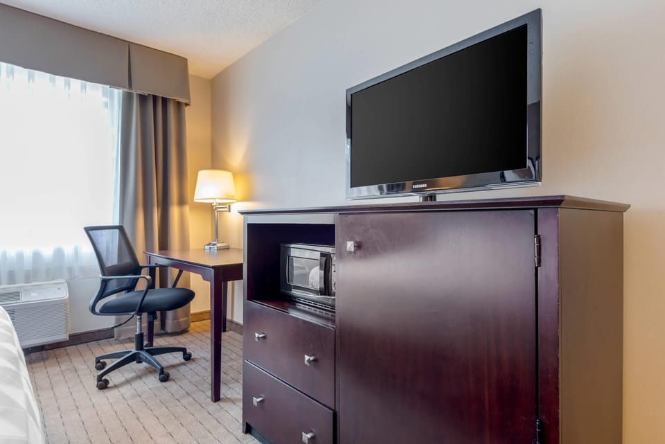Desk, laptop workspace, blackout drapes, iron/ironing board