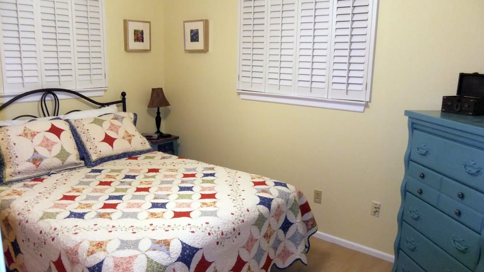 1st Bedroom with Queen Bed, Dresser, Chair, and Closet (not shown)