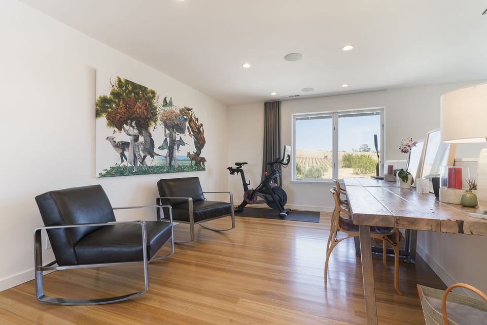 Open office area opposite the queen barn door bedroom. Peloton bike with a view!