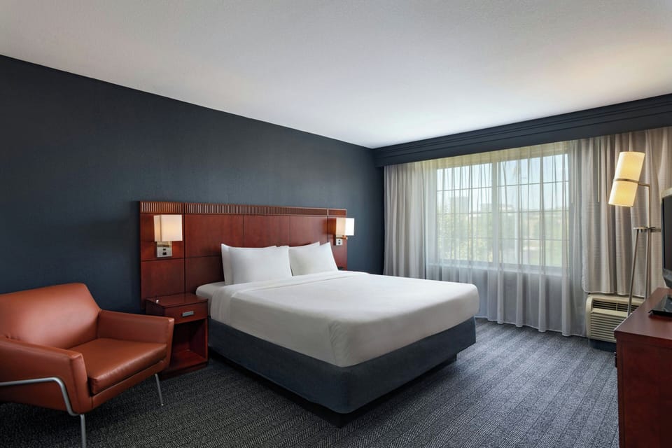 Premium bedding, desk, laptop workspace, blackout drapes