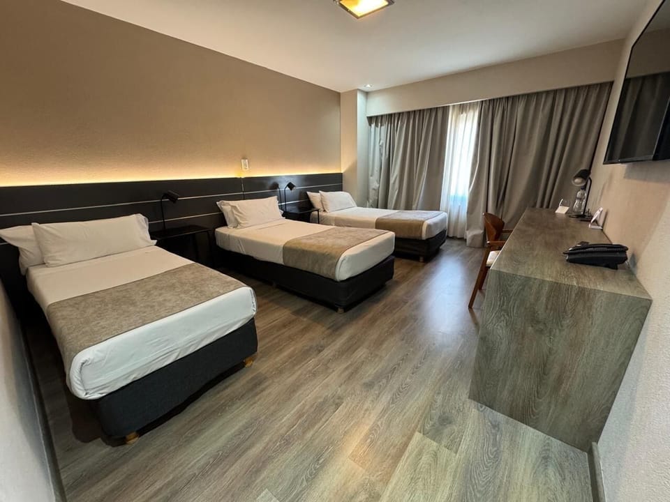 Triple Room | Minibar, in-room safe, desk, blackout drapes