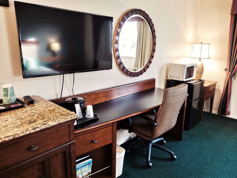 Premium bedding, desk, laptop workspace, blackout drapes