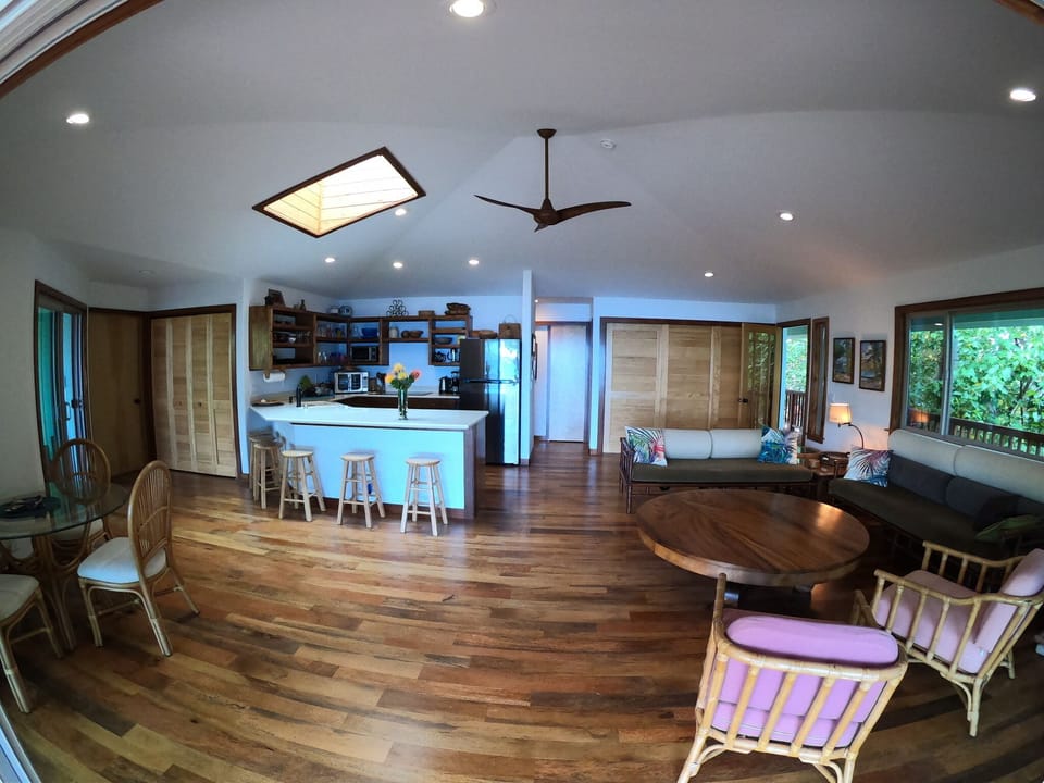 Wide angle of kitchen and living room.