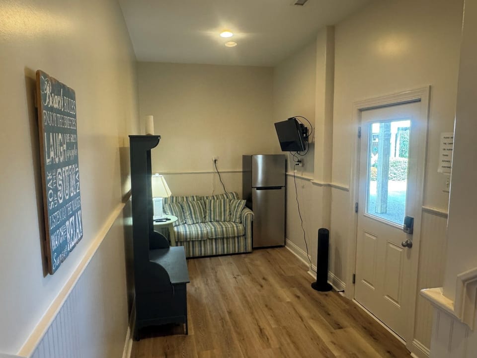 1st floor entry from carport. "Mancave"fridge, tv, loveseat-minute walk to water