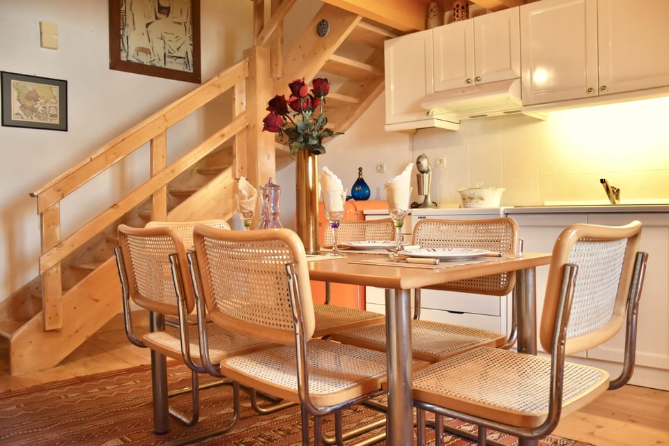 Fool equipped kitchen with dining area and the stairs to the second floor..