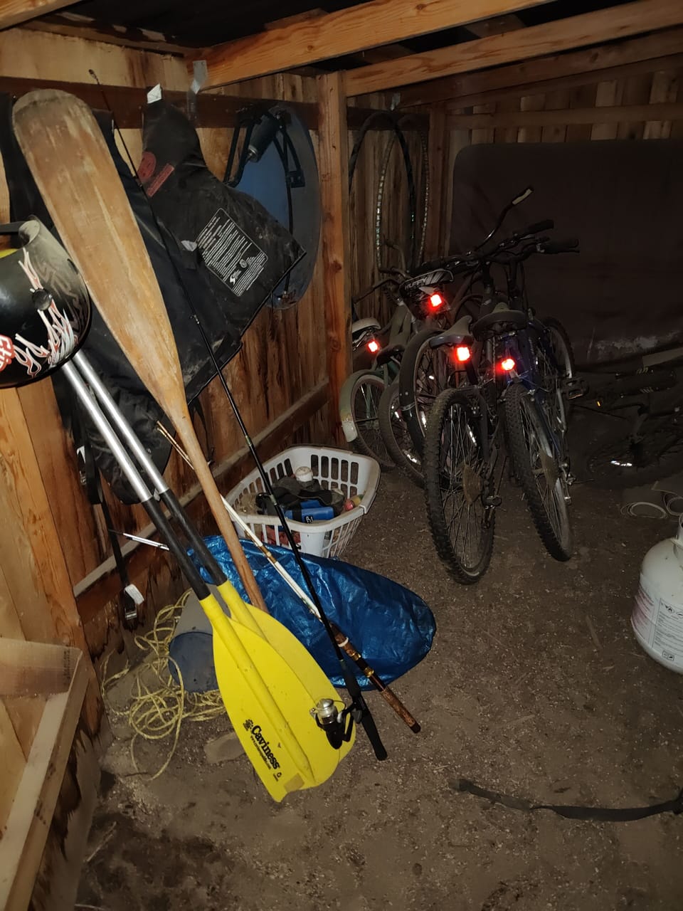 outdoor activities shed with bikes, canoe equipment, fishing gear, etc.