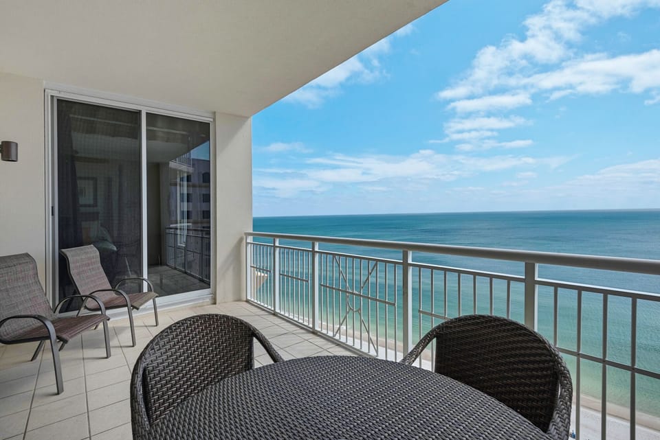 Spacious balcony with nice Frontgate table and chairs for eating and relaxing
