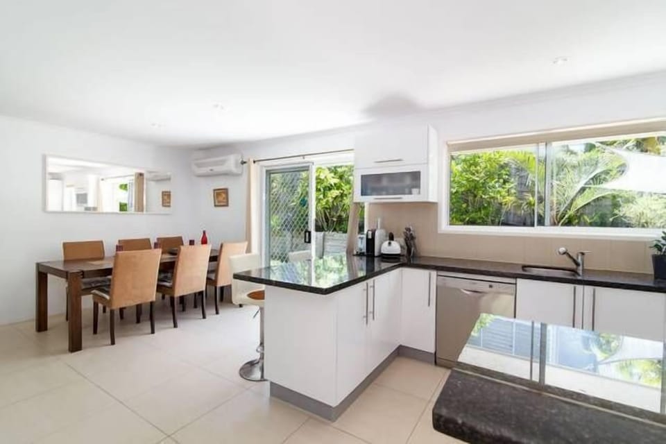 Granite breakfast bar adjoining air conditioned dining area