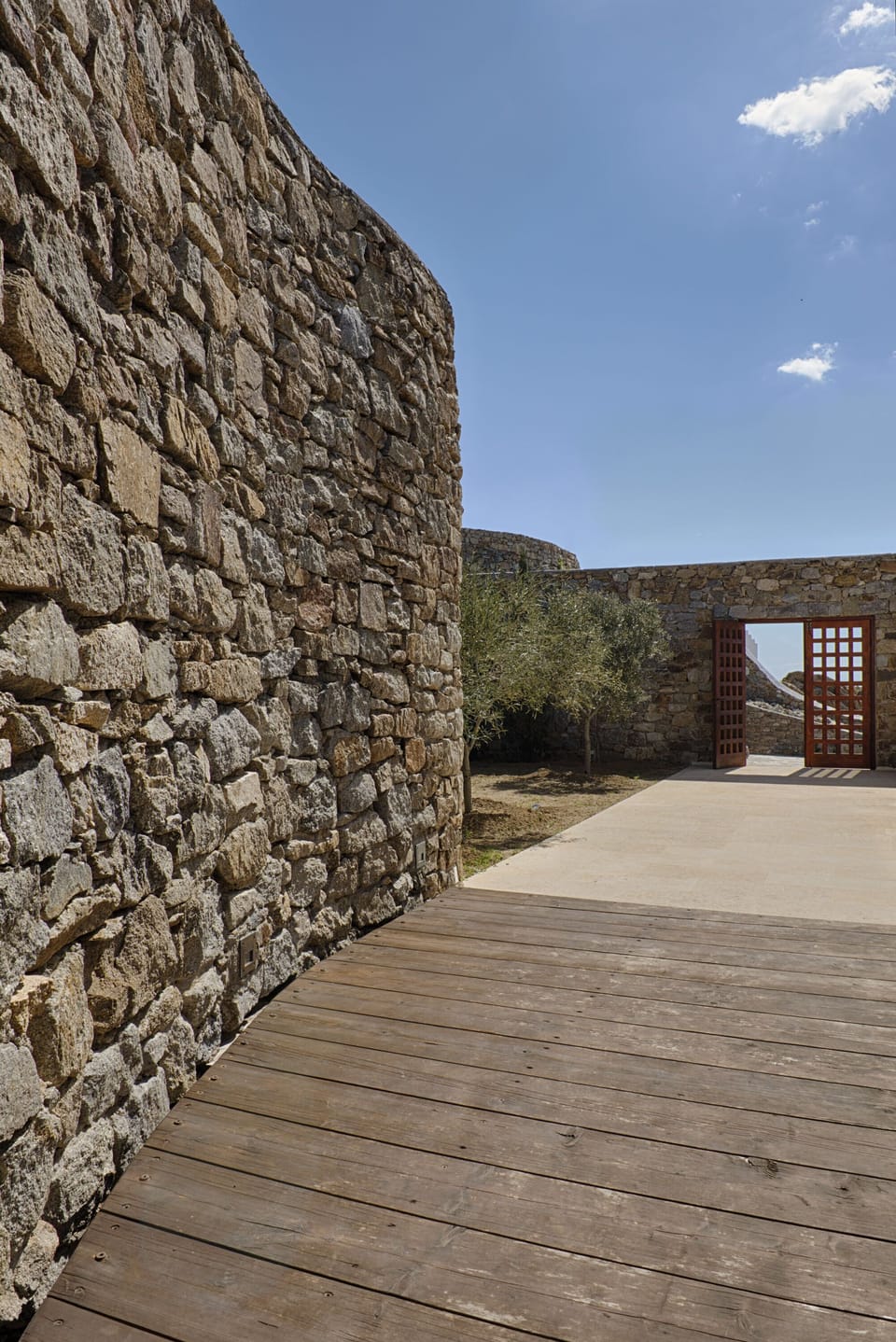 Olive tree garden, bioclimatic architecture including hand-made thick walls