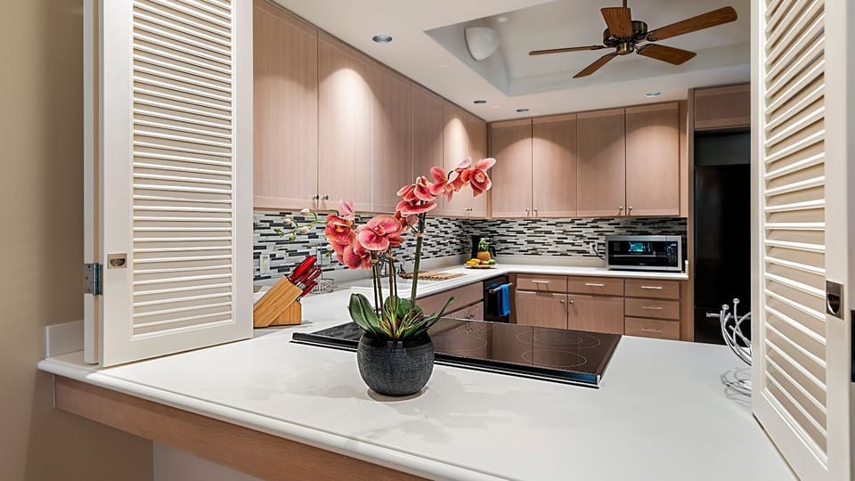 Kitchen with Cooktop, Refrigerator, Ceiling Fan, and Microwave