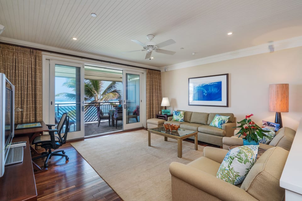 Living room with ocean view! - located in the Main Villa with pull-out gel memory foam sofa bed and 75" SMART TV and ceiling fan.