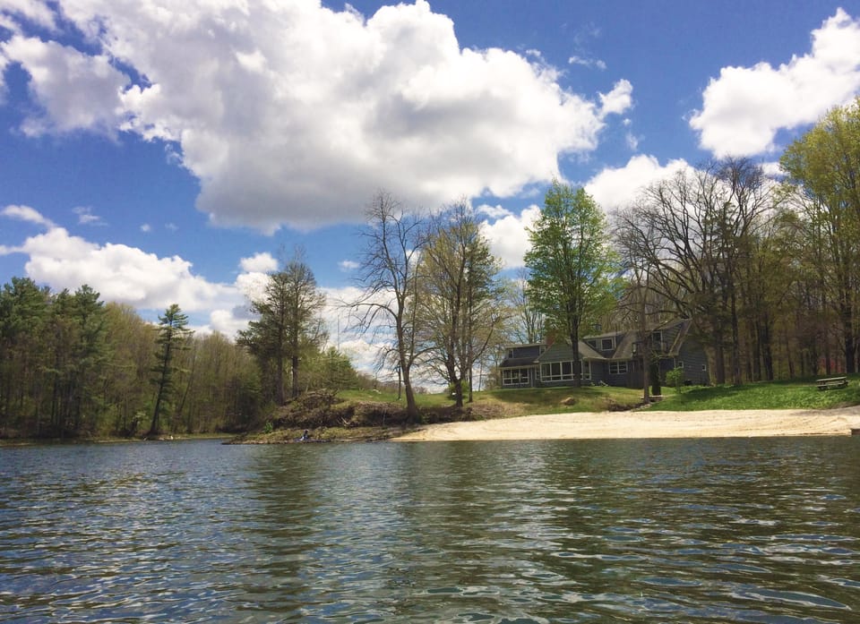 The Lake House's large, private beach as seen from the water.