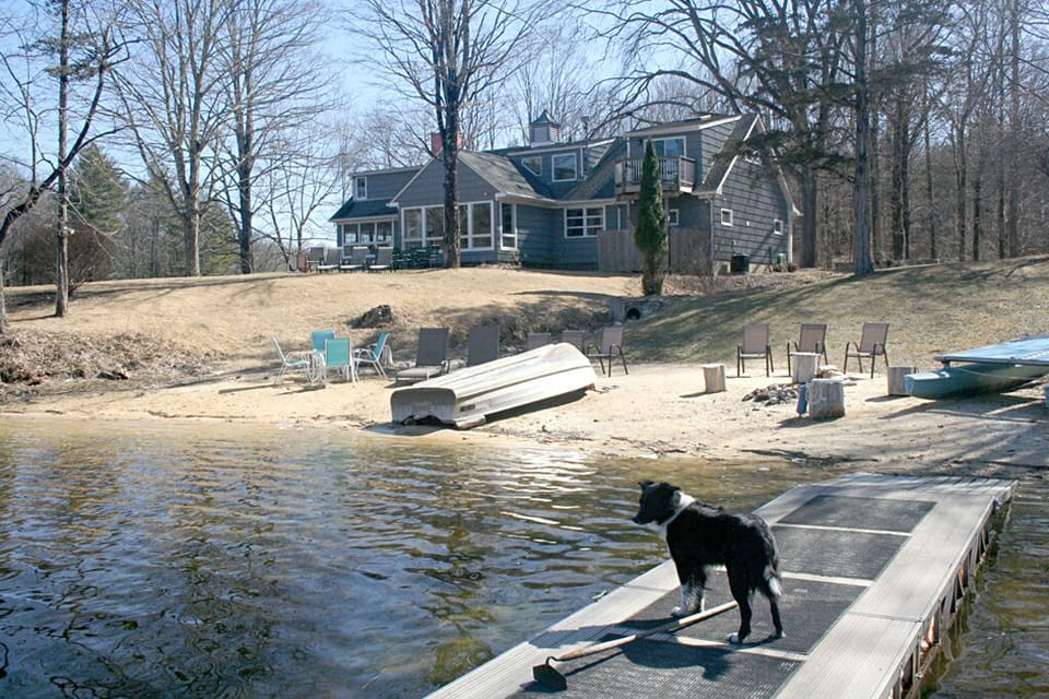 Private beach and back of house as seen from the dock in fall