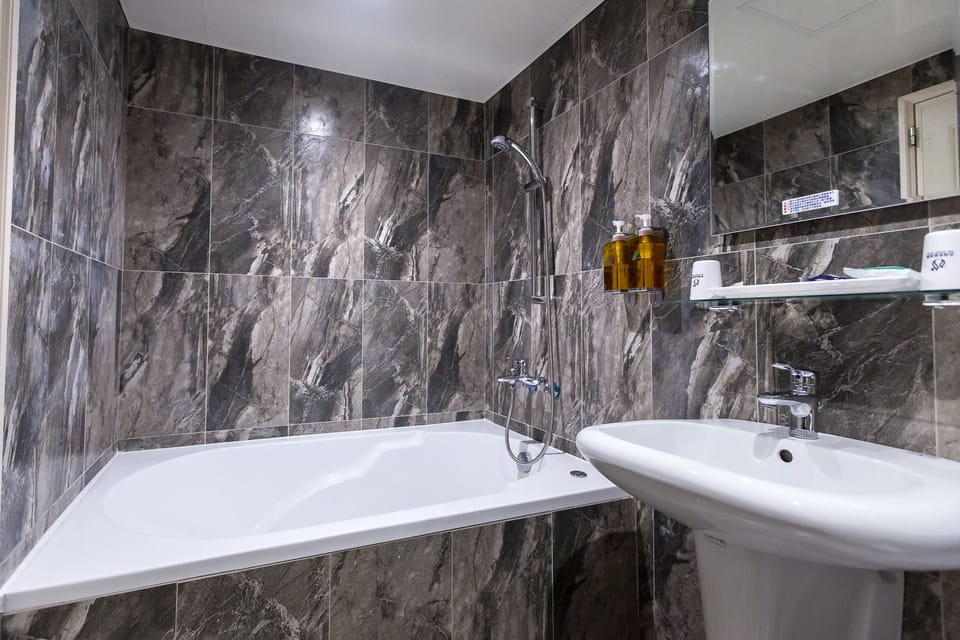 Business Double Room, 1 Queen Bed | Bathroom | Combined shower/tub, deep soaking tub, rainfall showerhead
