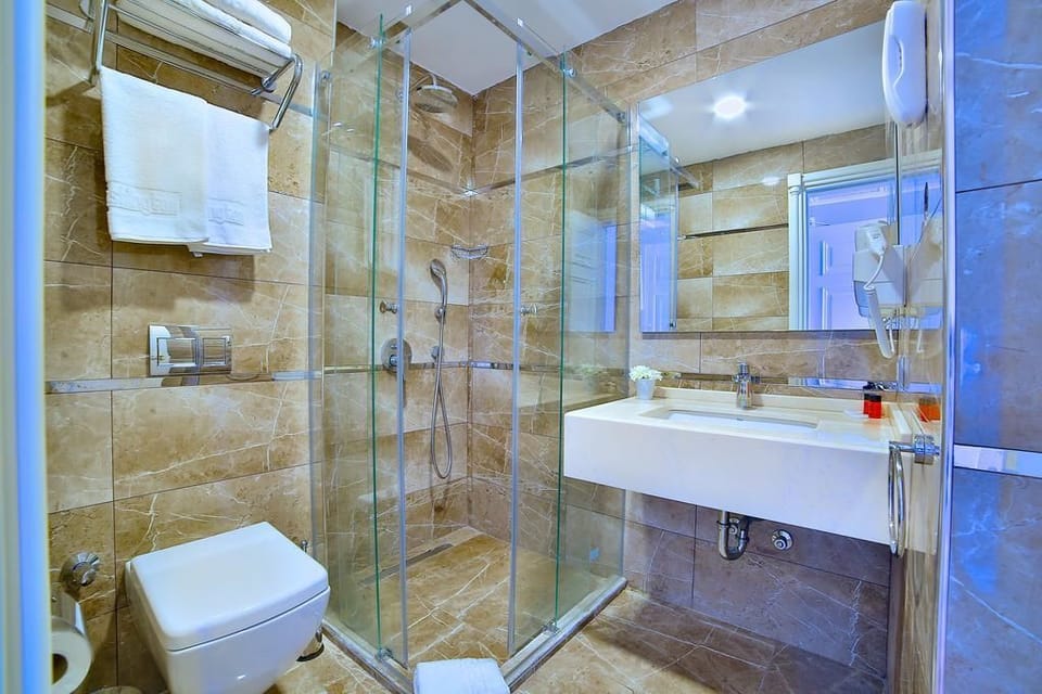 Shower, hair dryer, slippers, towels