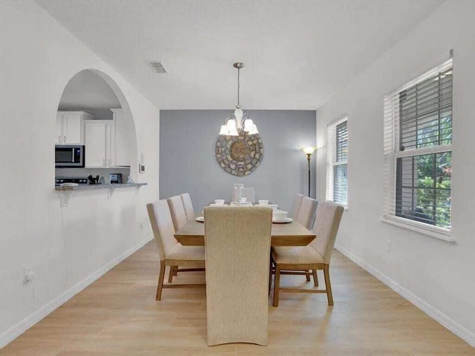 Bright and elegant dining area with seating for six, ideal for family meals or entertaining guests.