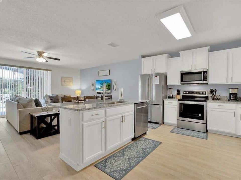 Fully-equipped kitchen with stainless steel appliances and a convenient open layout.