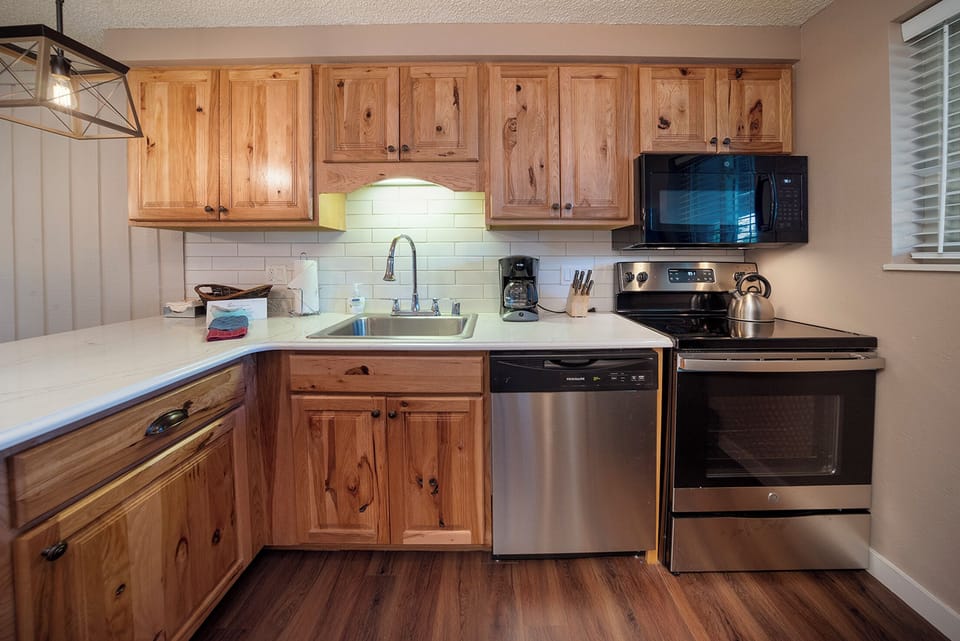 Your fully-equipped kitchen features warm wood cabinets, modern appliances, and everything you need to prepare delicious meals during your stay.