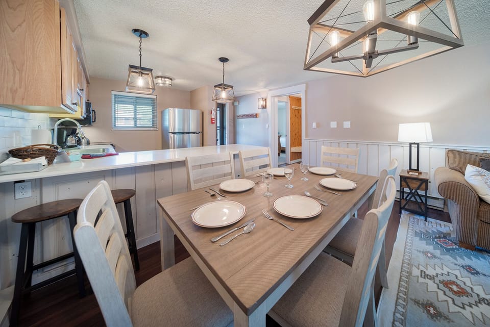 Your open dining space connects kitchen and living areas, with elegant lighting and seating for memorable meals together.