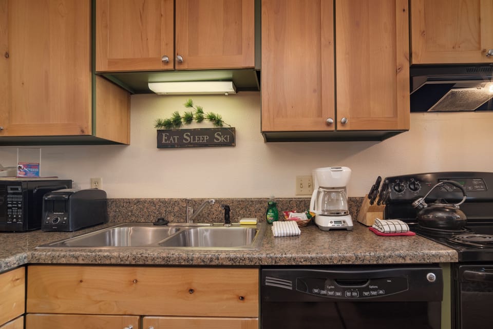 Your fully equipped kitchen features granite counters, modern appliances, and everything you need to prepare memorable mountain meals.