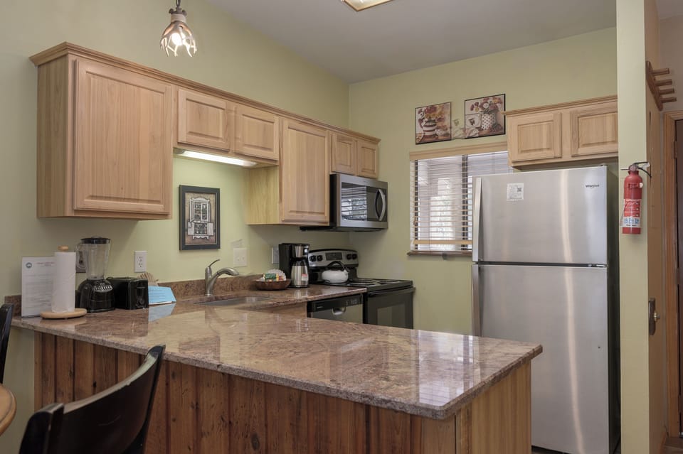 Your fully equipped kitchen features granite countertops and stainless steel appliances, perfect for preparing meals during your stay.