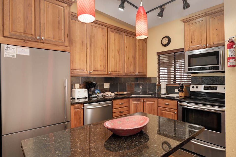 Your gourmet kitchen features granite countertops, wood cabinets, and stainless steel appliances—perfect for preparing memorable meals during your stay.
