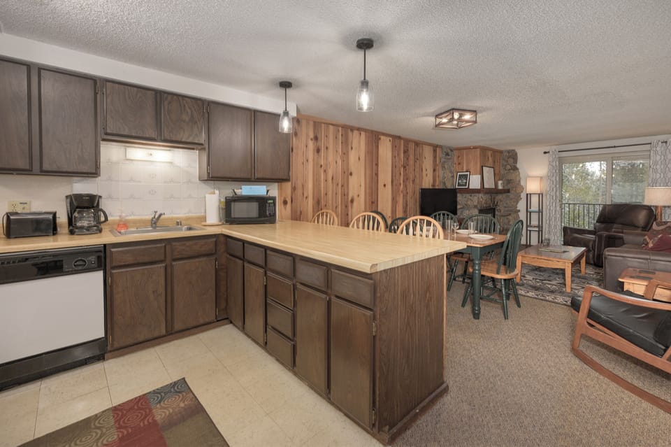 Cook your favorite meals in this welcoming kitchen with warm wood cabinets and cozy mountain cabin charm.