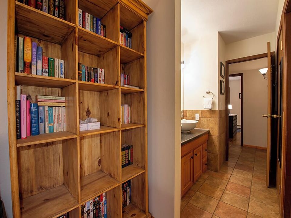 Curl up with a good book from your personal library wall, then refresh in the spacious bathroom just steps away.
