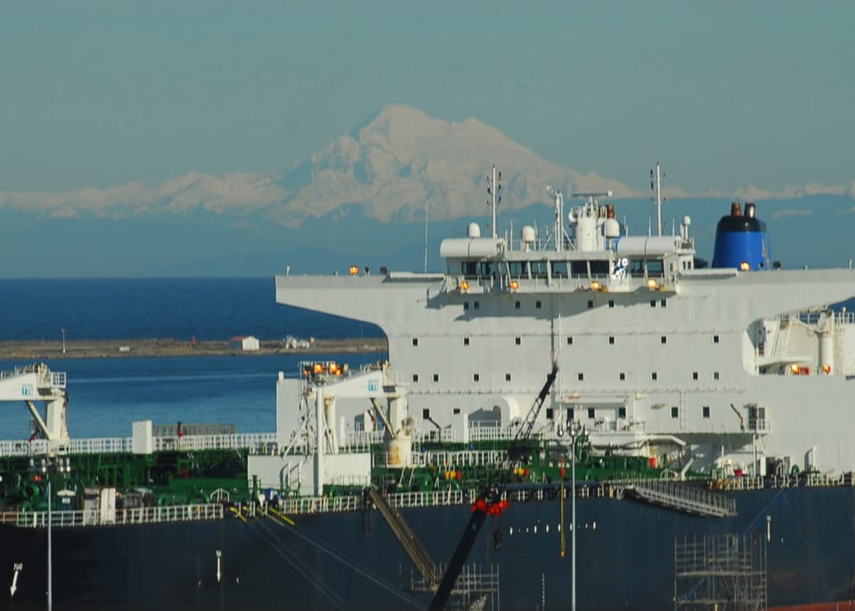 Mt. Baker looms beyond a supertanker located in Port Angeles Harbor.  