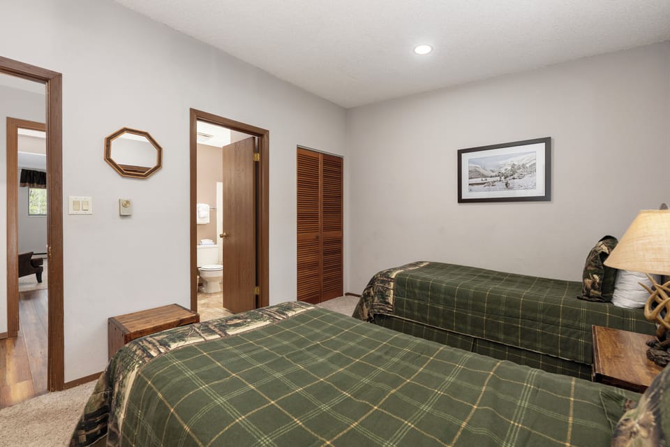Rest comfortably in your spacious twin bedroom, complete with warm wood touches and an adjoining private bathroom for your convenience.