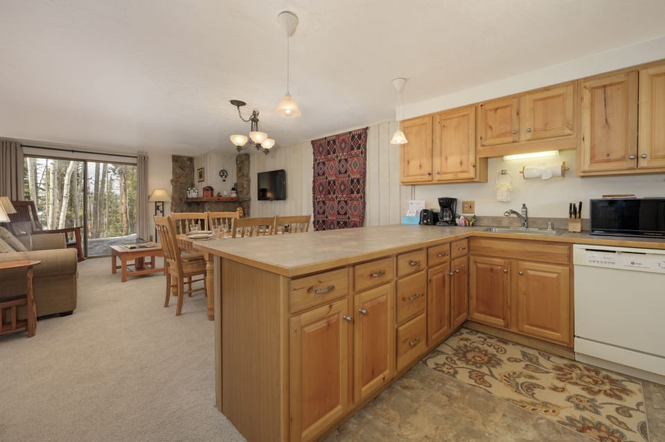 Cook your favorite meals in this bright kitchen with warm wood cabinets and plenty of counter space for preparation.