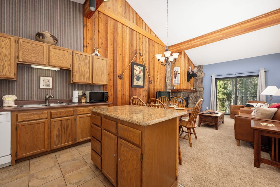 Gather around your spacious kitchen island while dinner simmers, then unwind by the stone fireplace in this cozy mountain retreat.