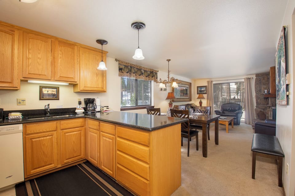 Your open-concept kitchen flows seamlessly into the dining and living areas, perfect for gathering with loved ones after mountain adventures.