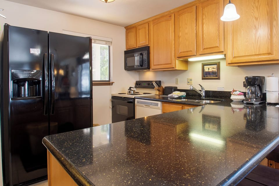 Your fully equipped kitchen awaits with granite counters, stainless appliances, and everything needed to create memorable meals during your stay.